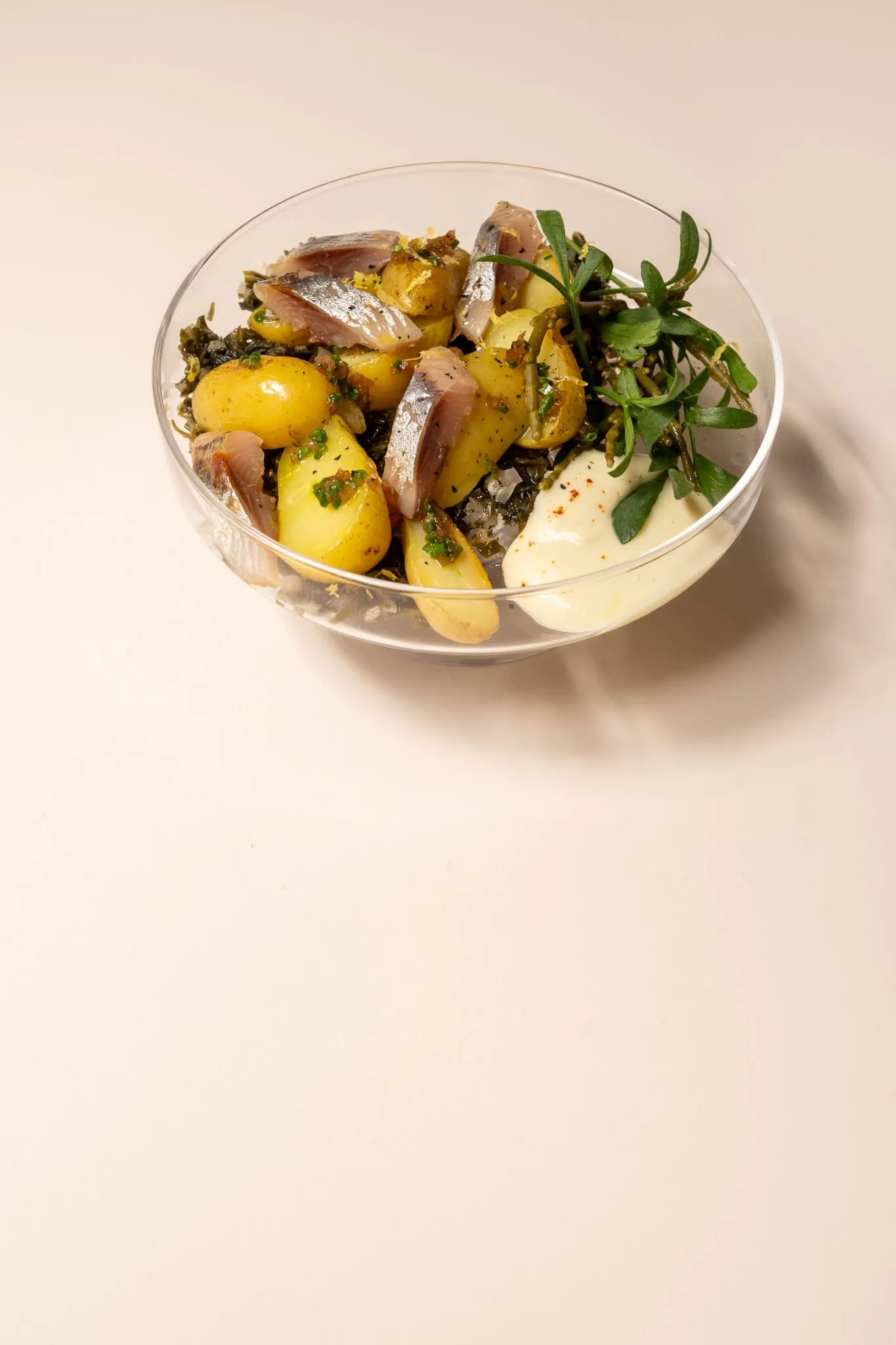 Salade de pommes de terre et hareng dans un saladier de verre